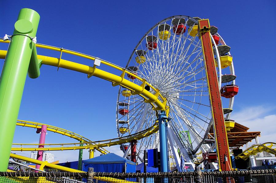 big roller coatser and ferris wheel in a park